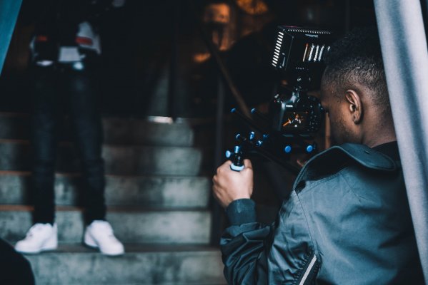 a person taking a recording at an event on steps